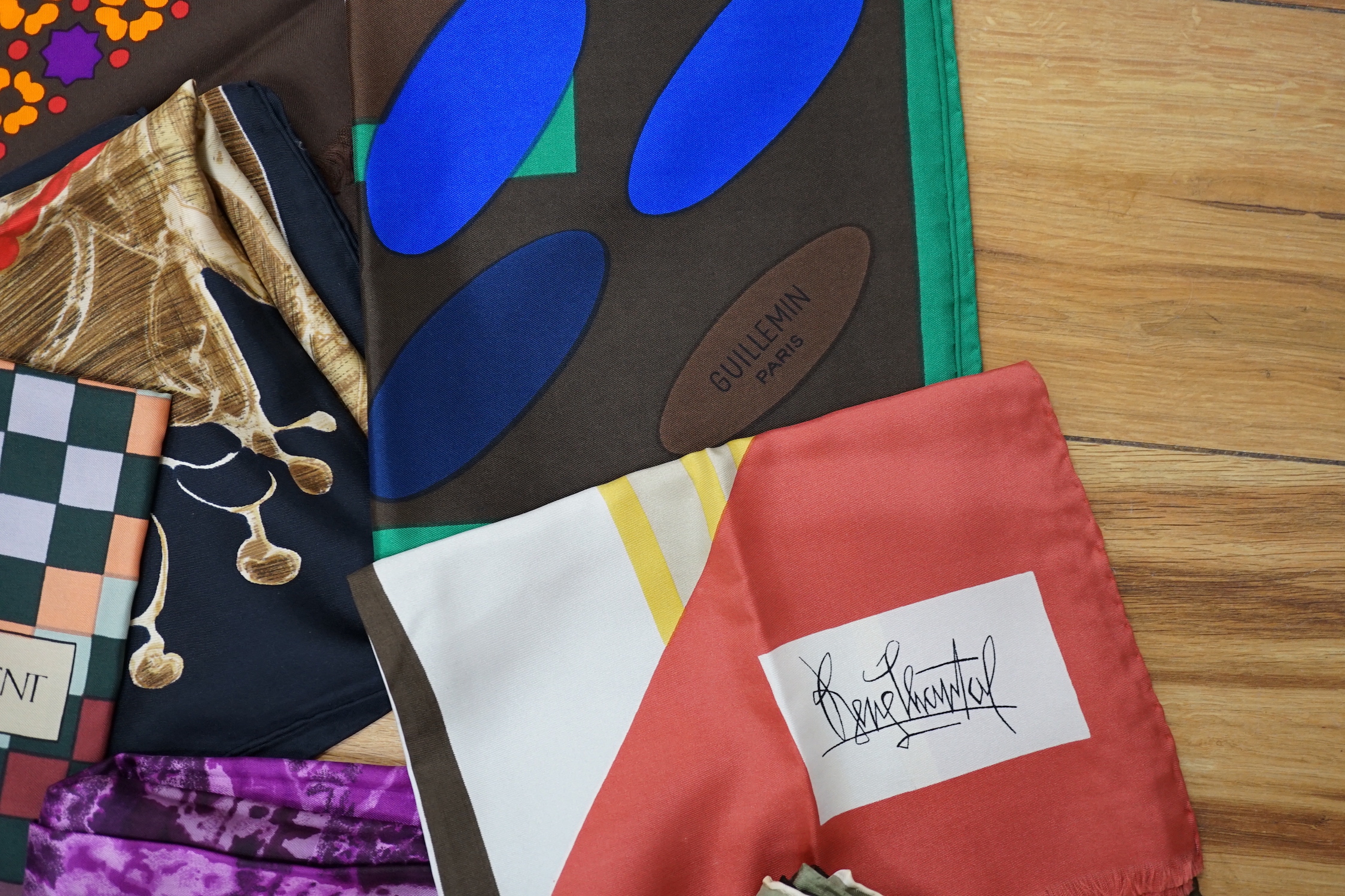 A collection of vintage silk scarves including Lanvin, Yves Saint Laurent, Maggy Rouff and one retailed by Harrods
